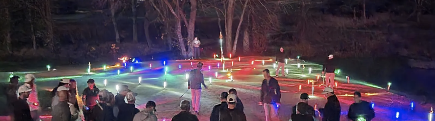 Golfers on putting green with glowing golf balls all over green