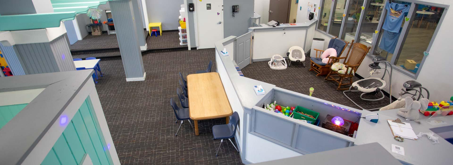 Child care area with rocking chairs and baby baskets at the Outer Banks Family YMCA