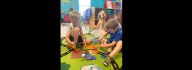 Kids at the Salem YMCA Family Center playing on a mat with toys