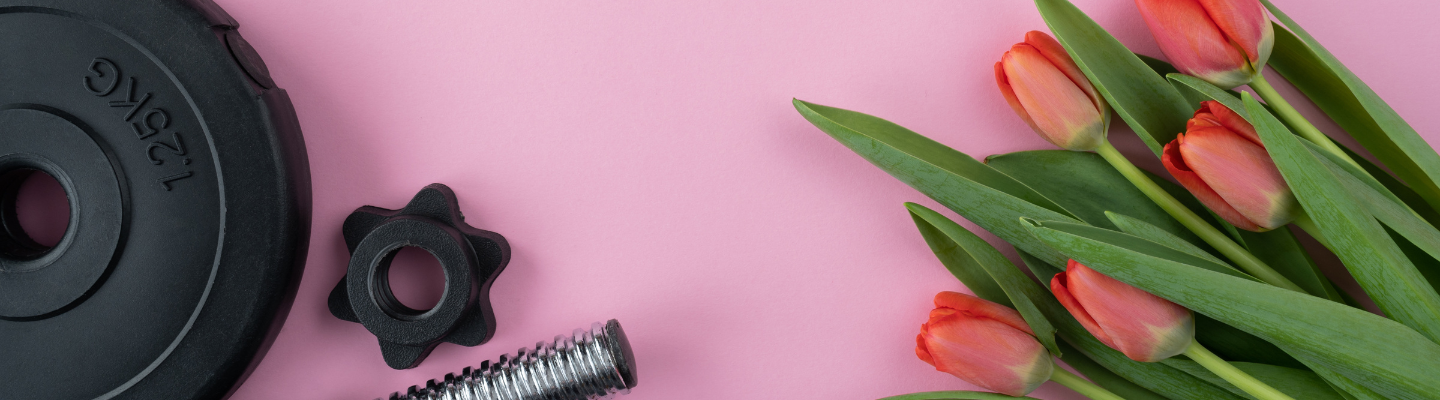 Pink background with weights and tulips for spring