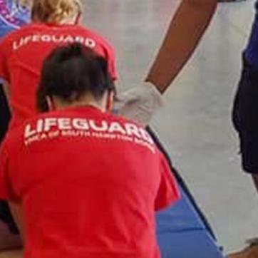 Dozens of YMCA lifeguard taking a CPR class