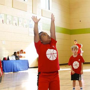 Young boys playing basketball in the Y's gymnasium