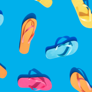 Blue background with pink, yellow, orange and blue flip flops
