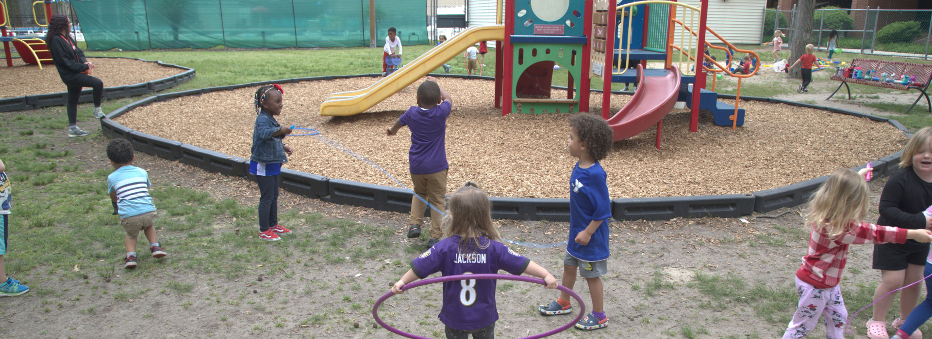 Kids playing on a playground at the Mt. Trashmore Family YMCA preschool
