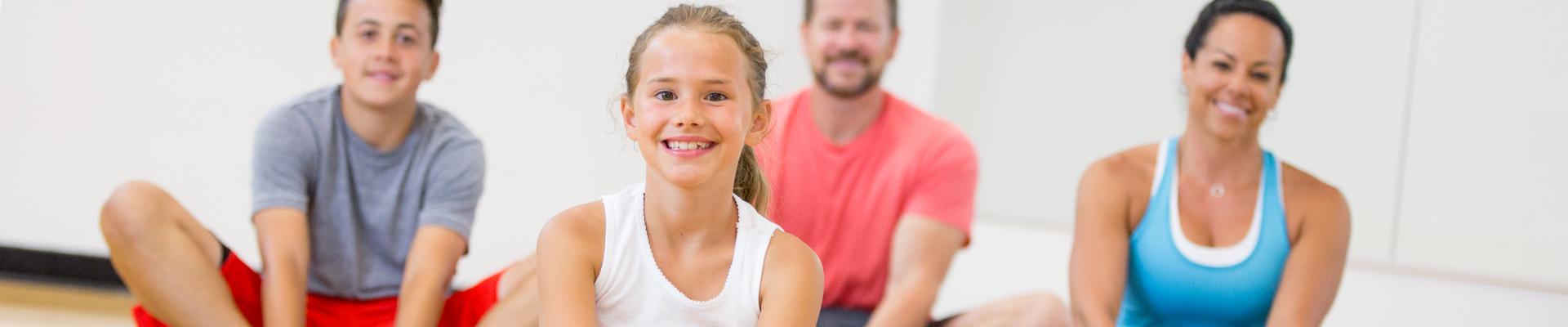 Family participating together in stretching class at the Y