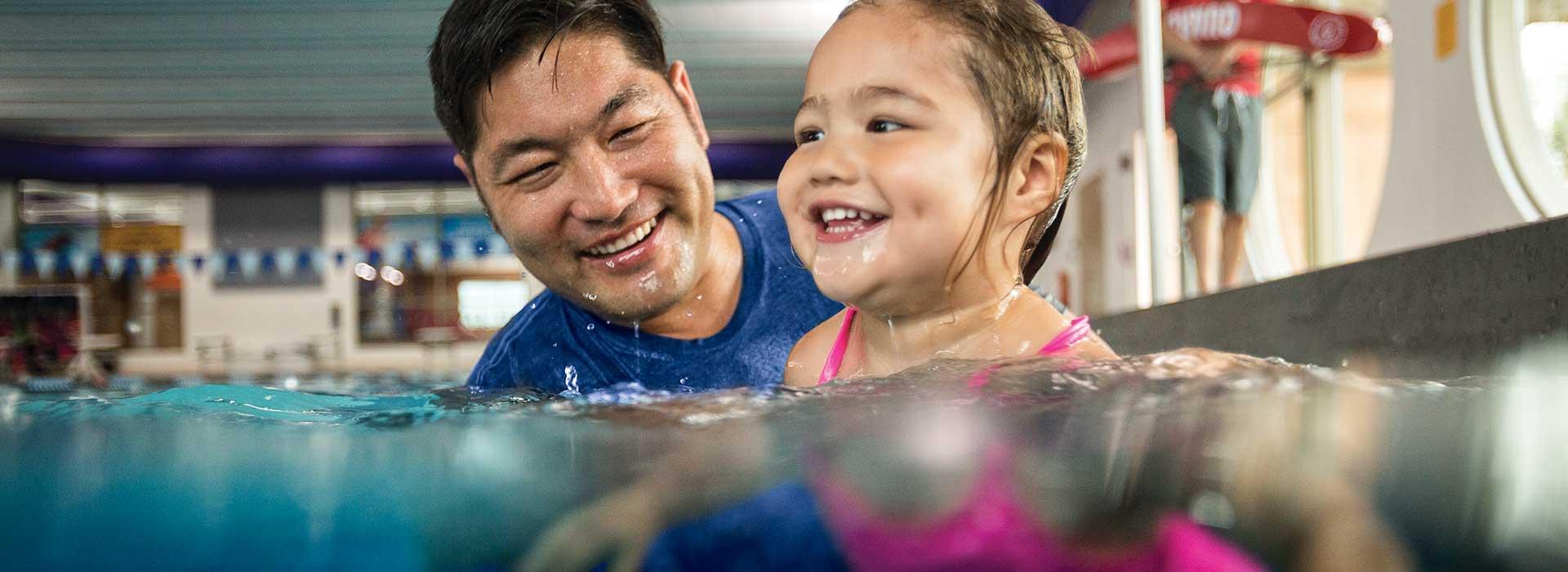 Little girl taking swim lessons with a YMCA Swim Instructor